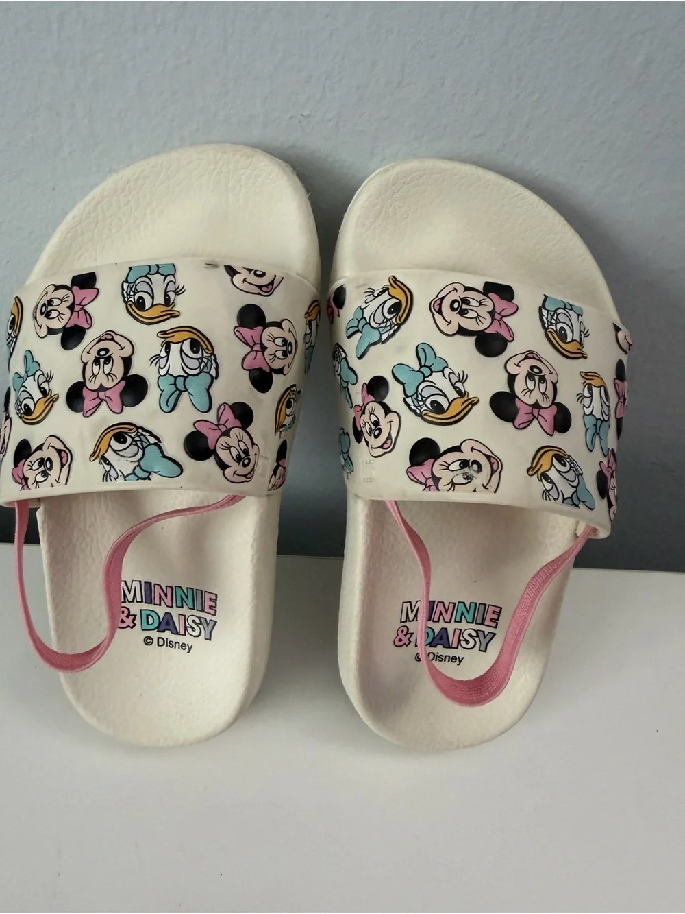 white slides feature a colorful Minnie Mouse and Daisy Duck character size 7t